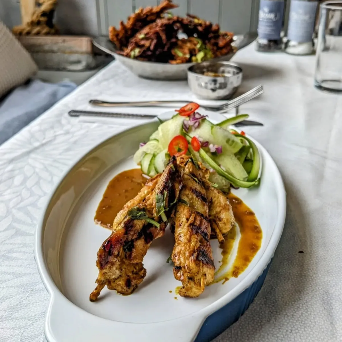 Chicken satay with cucumber salad and peanut sauce