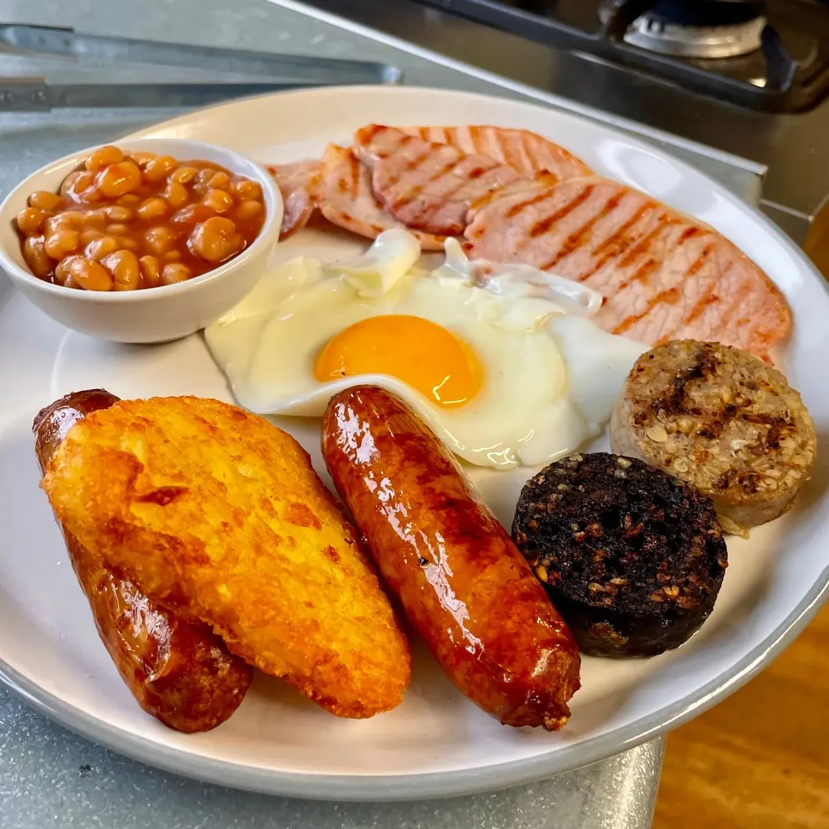 Full Irish breakfast with sausage, bacon, egg, pudding, beans and hash brown