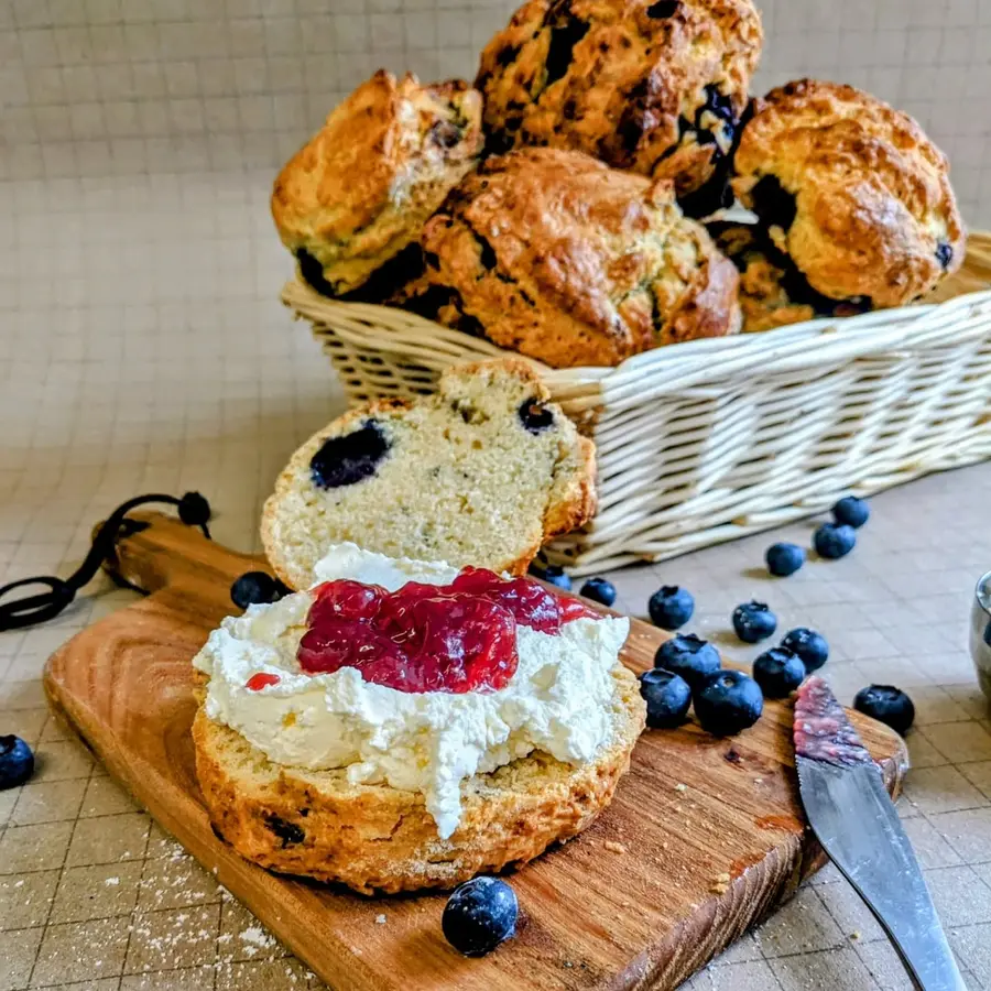 Homemade blueberry scones with cream and jam